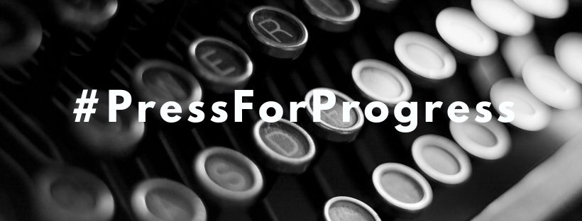 A close up black and white image of a typewriter with the words "#PressForProgress" overlaid. 